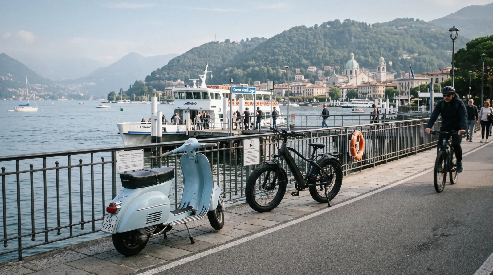 An e-bike leaning on the lakefront railing in Como in the morning with the ferry pier behind, bike rental in Como