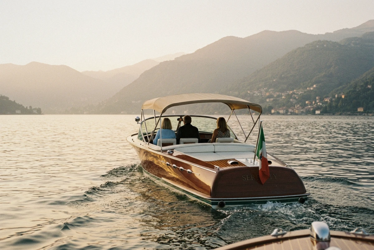 Varnished mahogany launch under its sunshade on a classic wooden boat tour on Lake Como, Italy