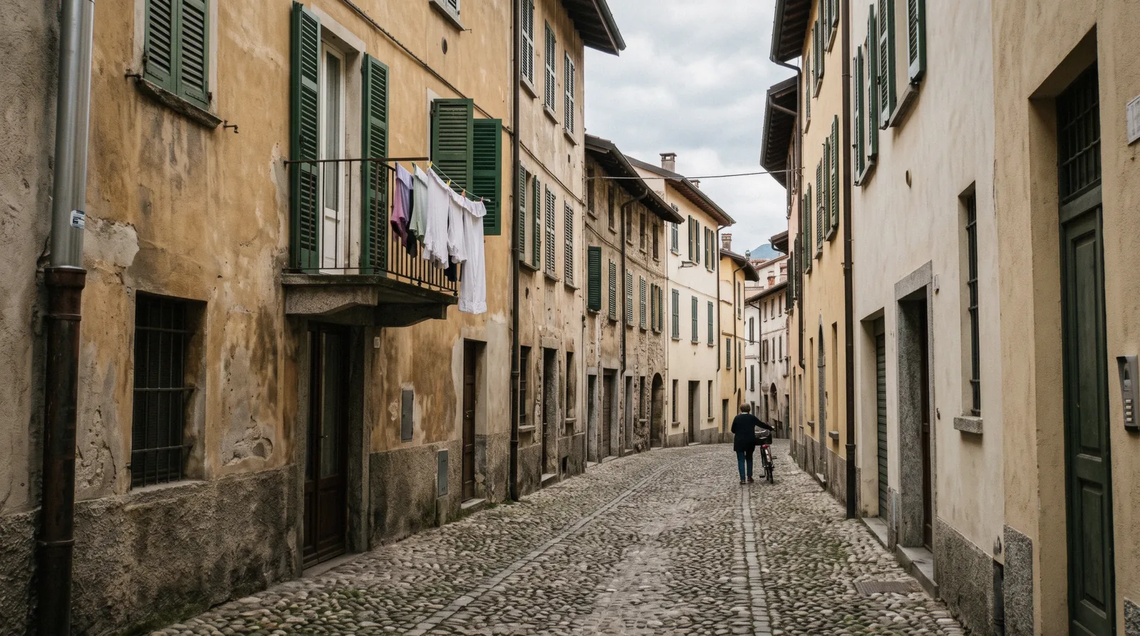 Shuttered apartment windows above a narrow street in Como old town, renting Como apartments