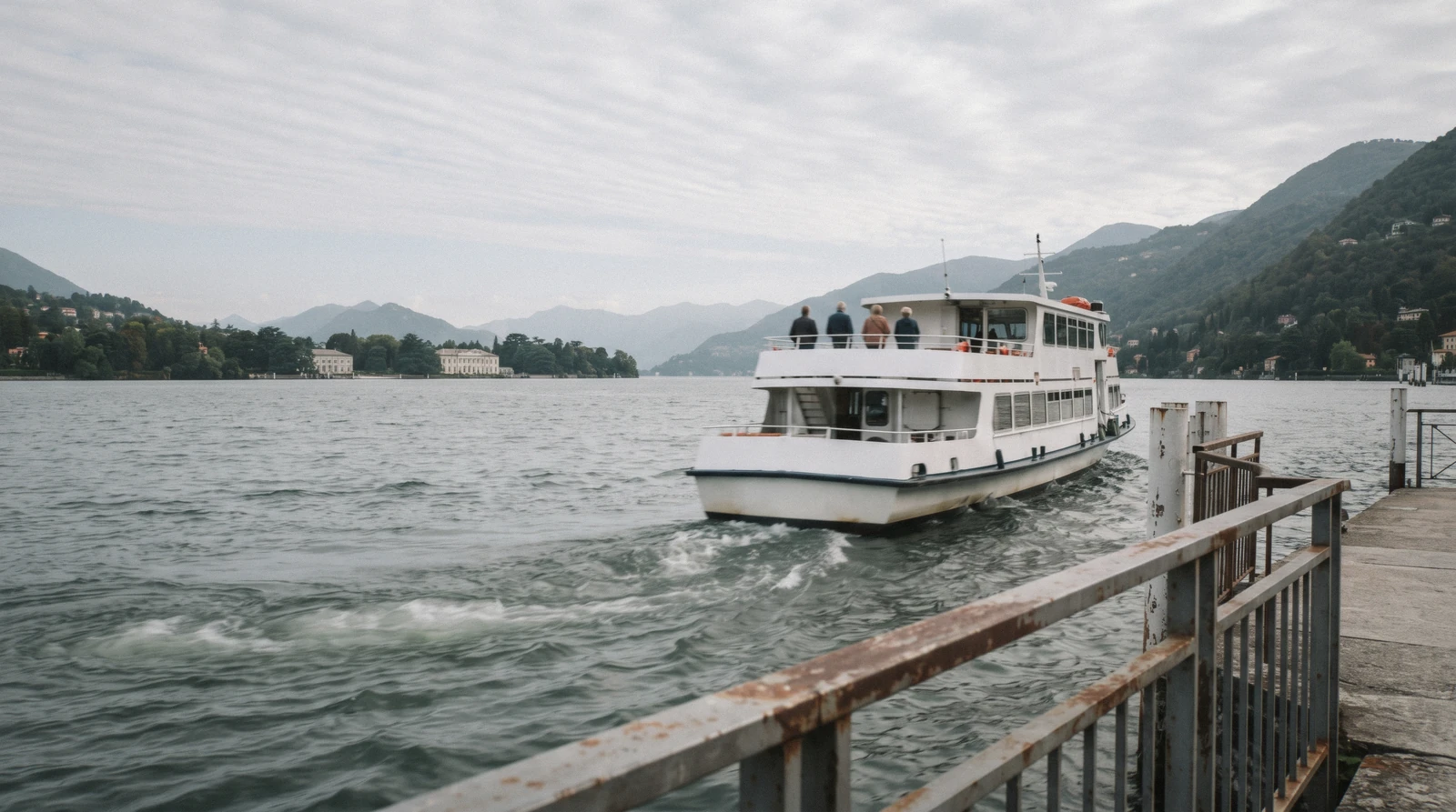 A passenger ship pulling away from the Piazza Cavour landing stage in Como, the Como ferry heading up the lake toward Bellagio