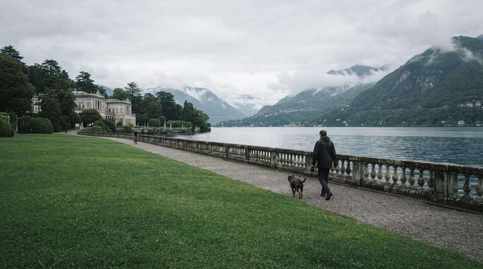 The lakeside lawn and balustrade of the Villa Olmo park on an overcast morning, one of the free things to do in Como
