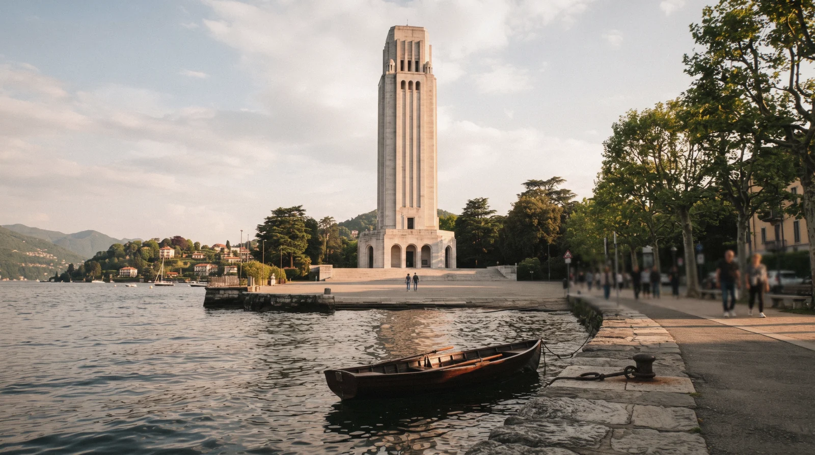 The stone Monumento ai Caduti tower on the lakefront near the Tempio Voltiano in Como, Italy
