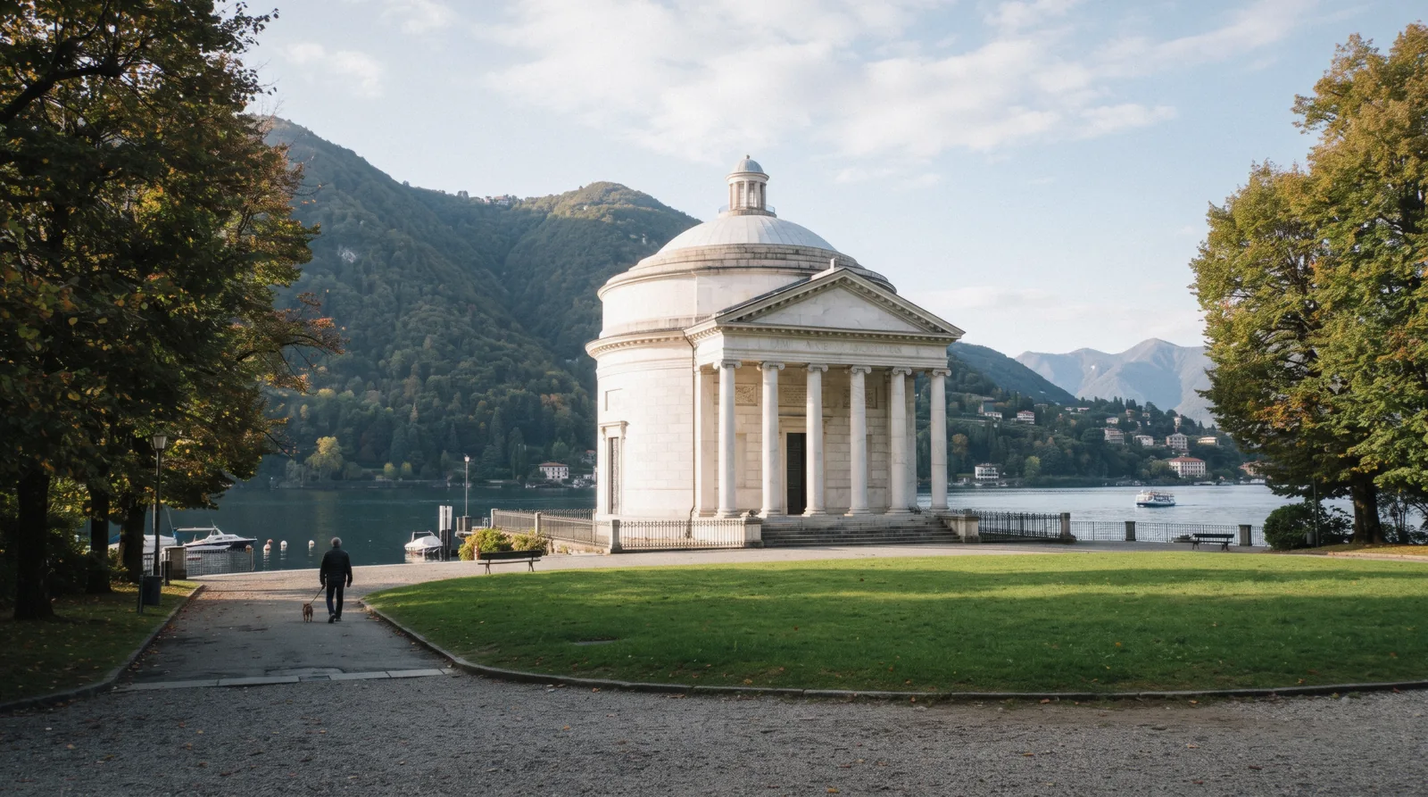 The round white neoclassical Tempio Voltiano among the lakeside gardens, the tempio voltiano museum in Como, Italy